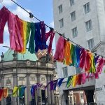 Coloured ribbons flying over head in city streets