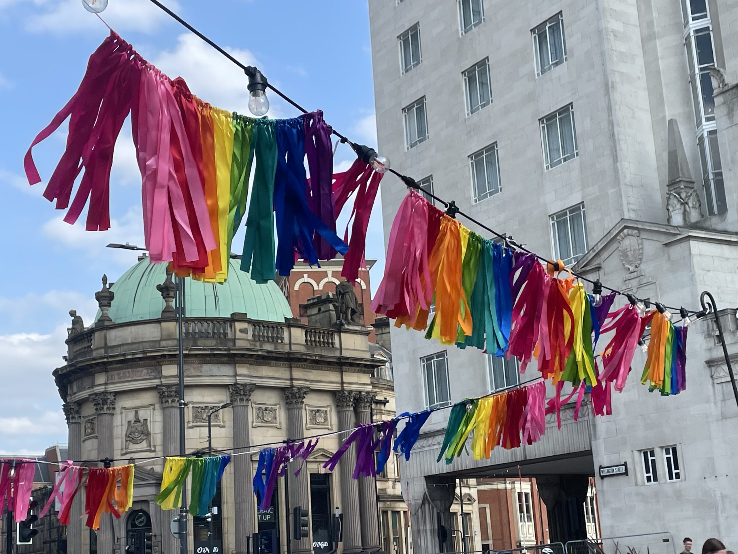 Coloured ribbons flying over head in city streets