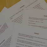 Scripts from various hospitality workers on a table